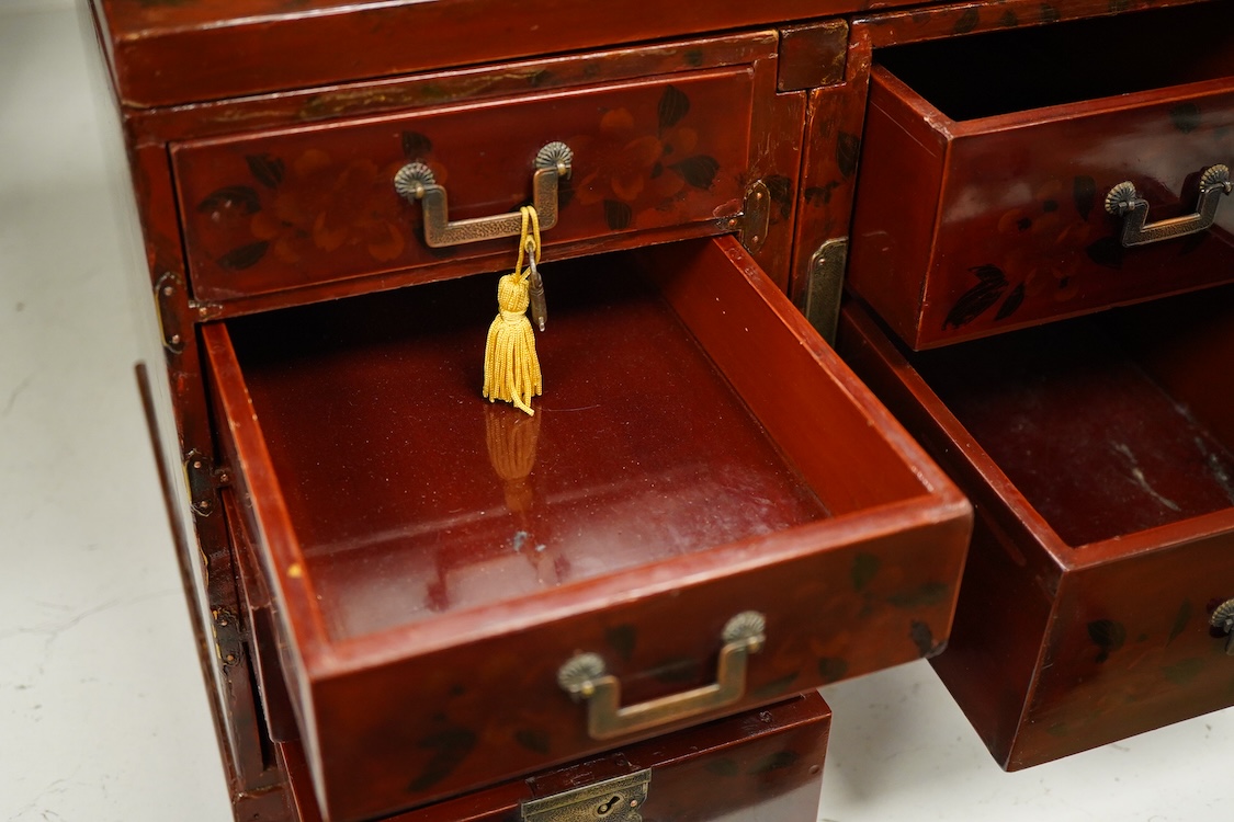 A Japanese floral lacquer table top cabinet, Taisho period, 36cm wide, the top panel is removable to form a twin pedestal cabinet
